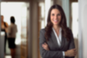 Woman in a business suit smiling at the viewer