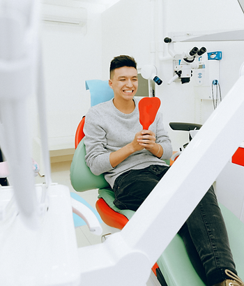 Dental Patient checking smile in mirror