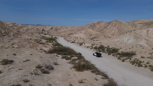 Drone view of a Jeep on a dirt road through the Anza-Borrego badlands