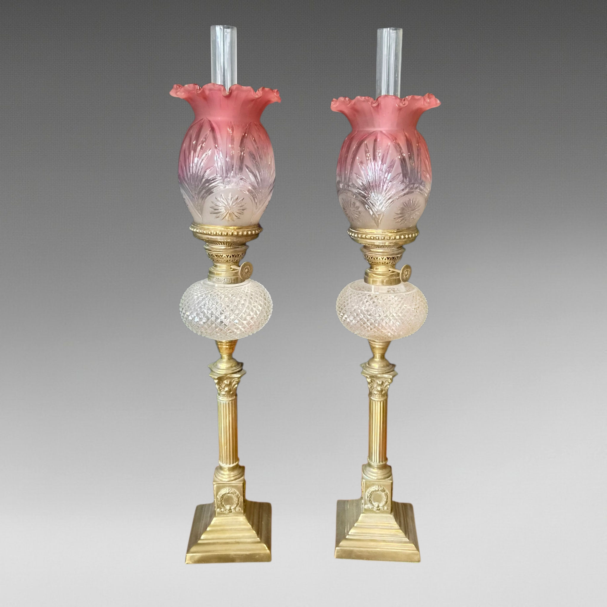 A Matched Pair Of Small Victorian Oil Lamps With Cranberry Glass Shades