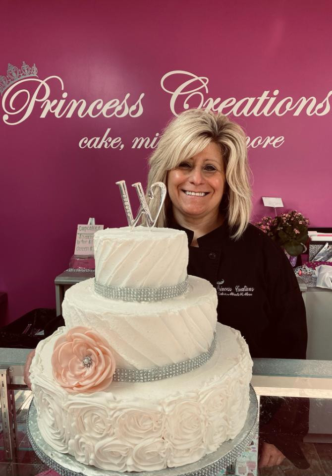 Owner with White Wedding Cake