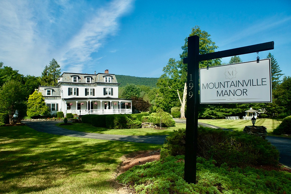 "Mountainville Manor" Sign with Mansion in Background
