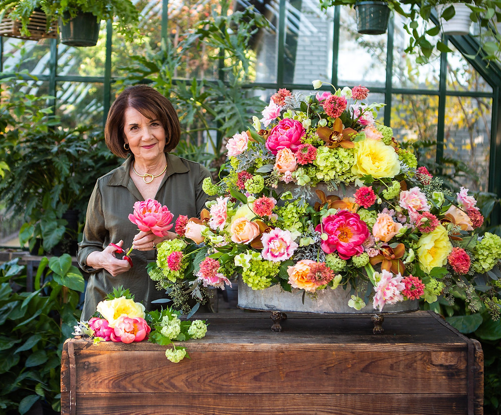 Photo of Dorothy with one of her large and colorful flower arrangements.