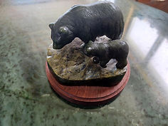 A stone sculpture of two bears, one large and one small.