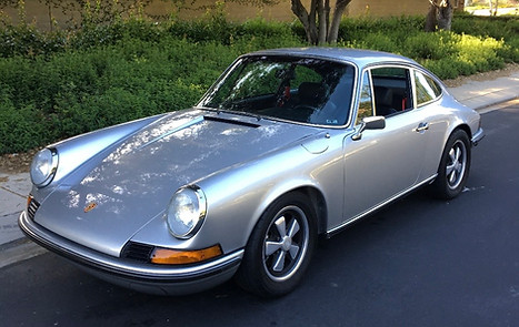 Silver Porsche vehicle in a street setting