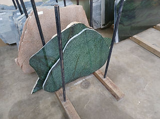 A big, flat, and green stone.