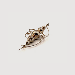 gold tone orbit brooch
