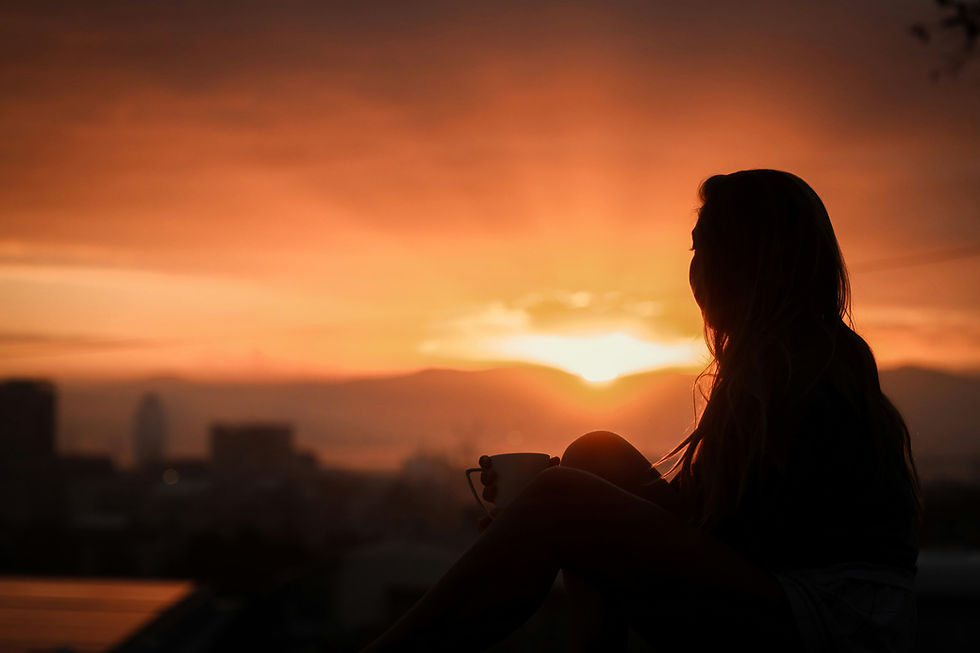 Christian widow reflecting in quiet light, beginning her healing journey after suicide loss