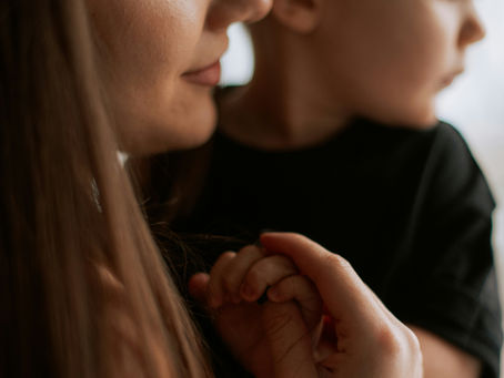 Christian widowed mom comforting her child during grief—hope and healing for grieving families after loss