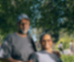 Smiling couple in park, wearing matching gray shirts