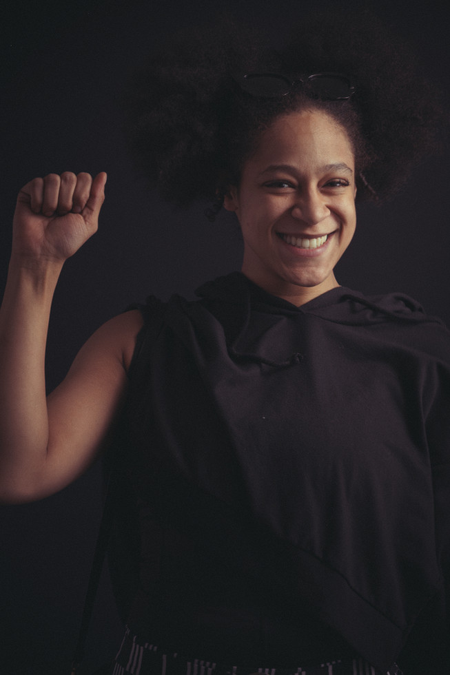Women smiling at the camera with right fist in the air