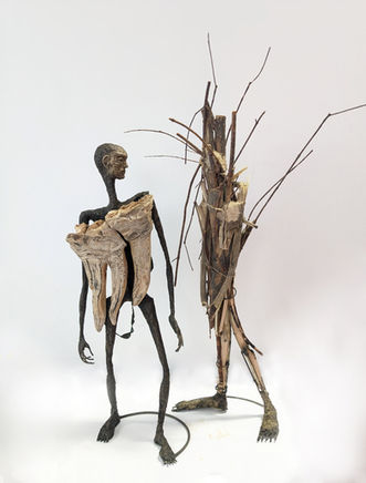 2 abstracted figure sculptures with wood