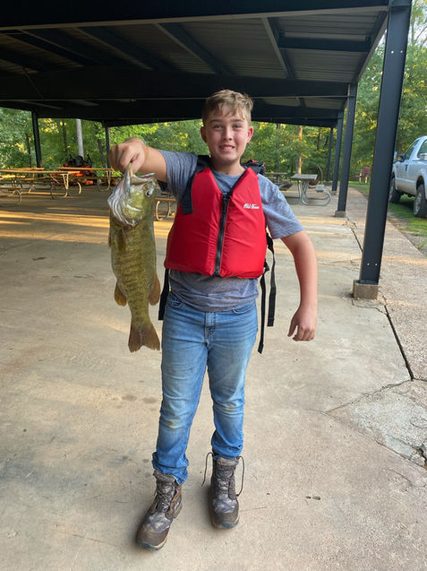 Boy holding fish at Last Wild River Lodge & Venue