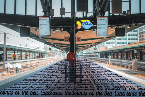 Poster for Under Water Art Exhibit, there's a tunnel and a red train with fish and bubbles