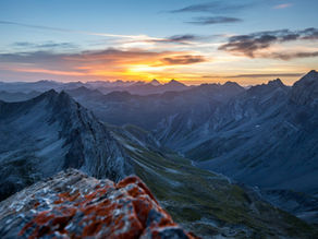 A breathtaking sunrise over a mountain range, casting golden light over the rugged peaks and valleys. The scene evokes a sense of calm, stillness, and perspective—mirroring the serenity and focus that mindfulness brings to the classroom.