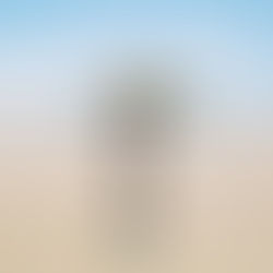 Teacher practising mindfulness on a quiet beach, letting go of end-of-year teacher stress and restoring wellbeing in the final weeks of school.