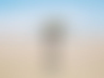 Teacher practising mindfulness on a quiet beach, letting go of end-of-year teacher stress and restoring wellbeing in the final weeks of school.