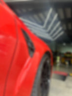 Close-up view of a luxury car engine being inspected with diagnostic tools