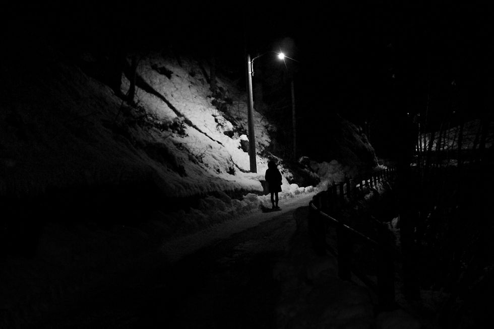 Under a light in a dark winter night