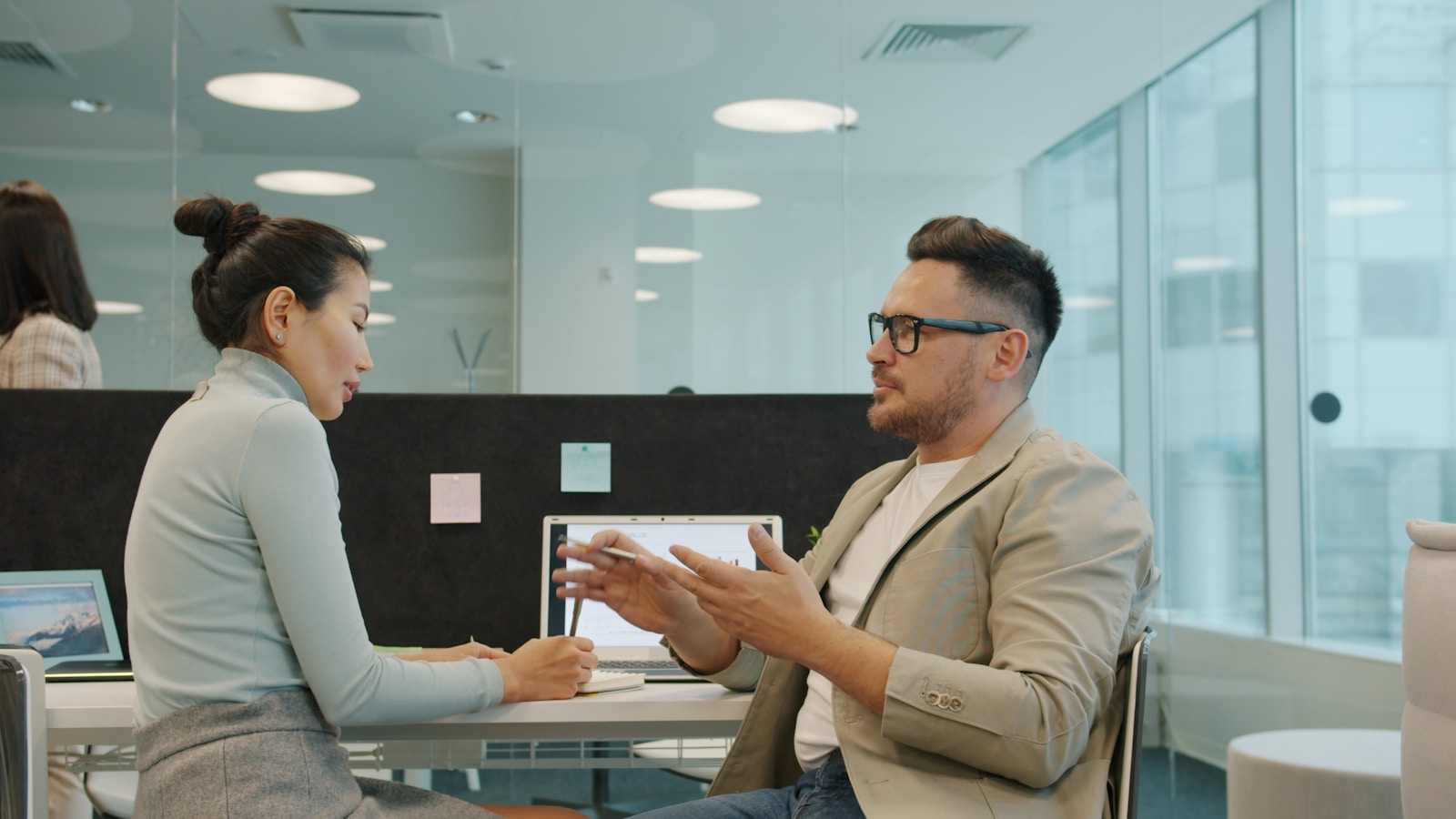 Two colleagues planning work in a modern office