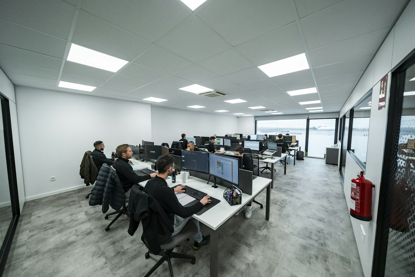 Technical team working at computer stations in an engineering office