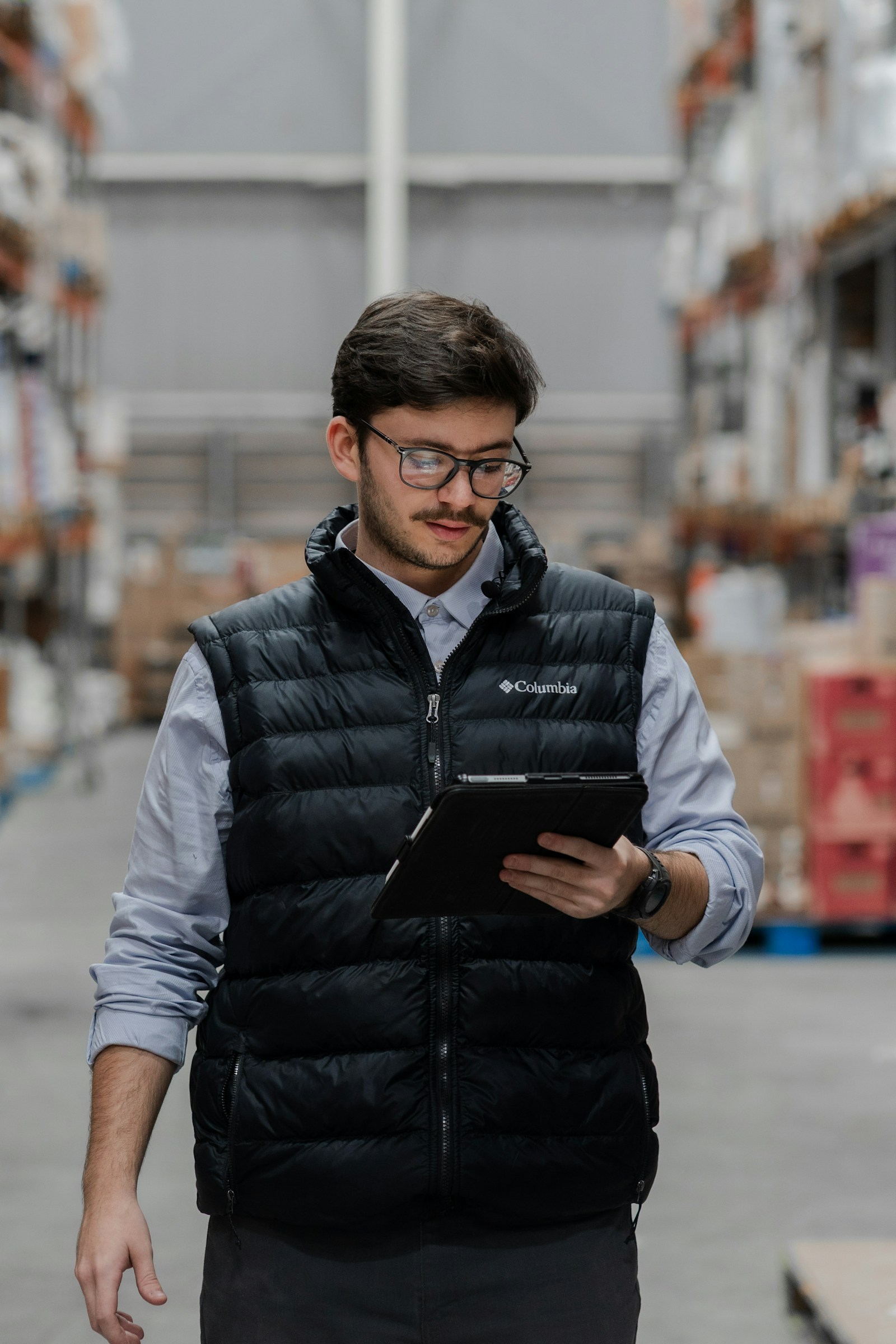 Warehouse professional using a tablet to review operational training performance
