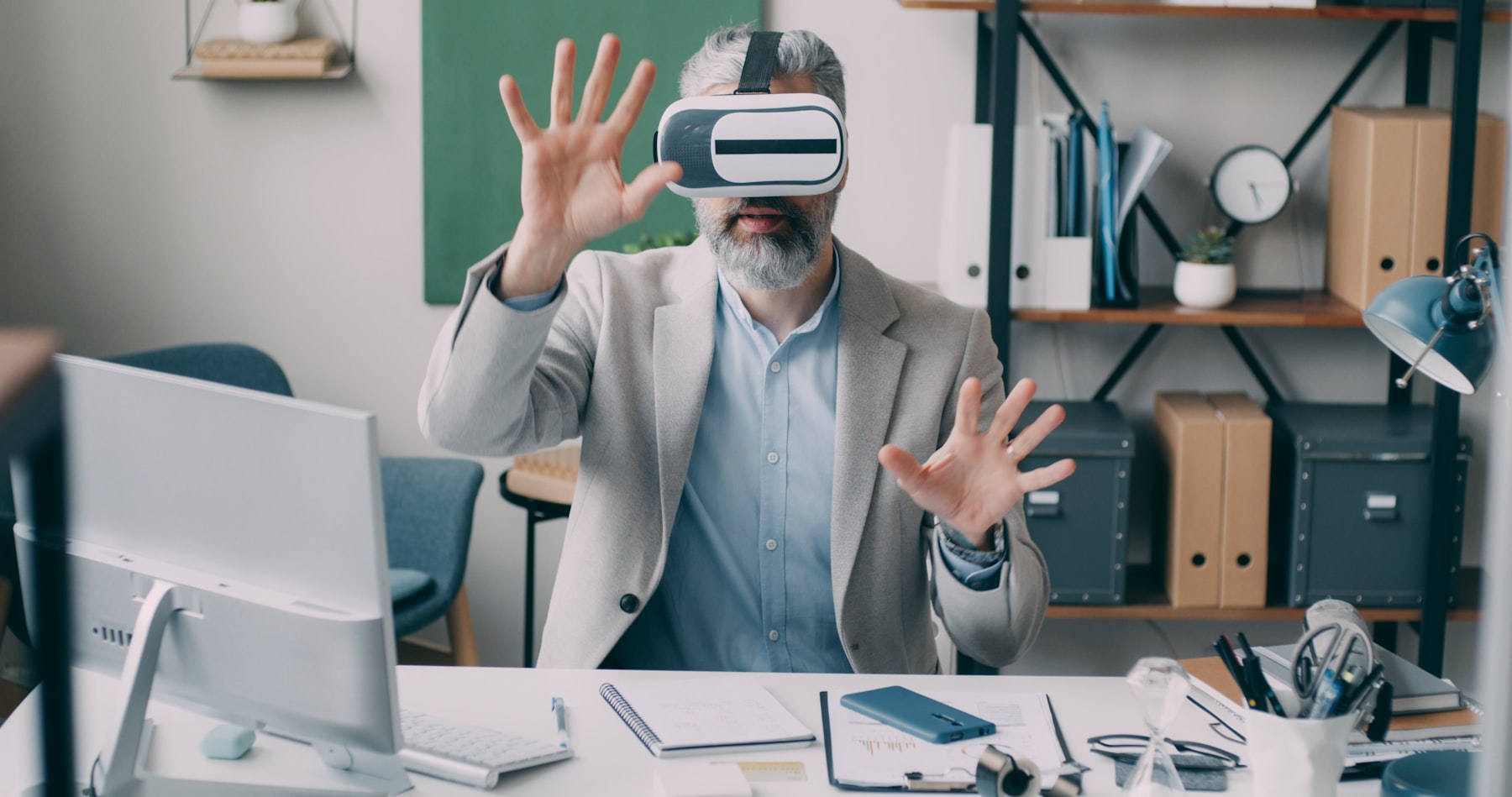 Business professional using a virtual reality headset to explore a spatial computing environment