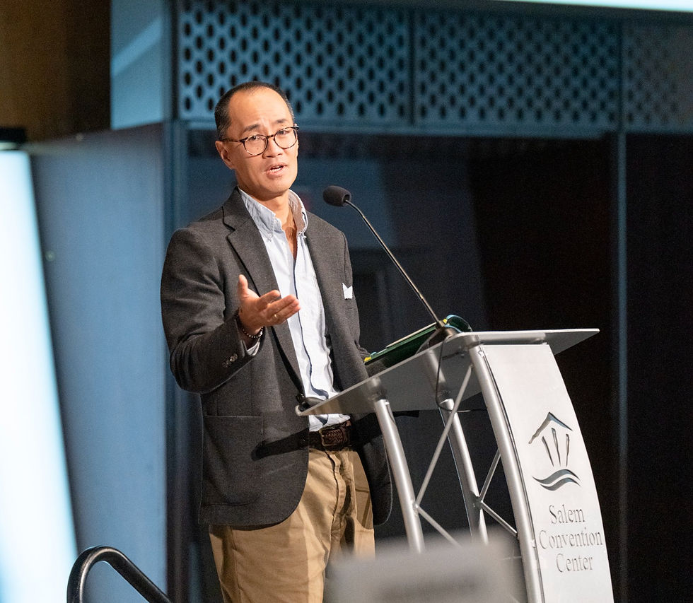 Quang Truong speaking at SEDCOR's 2026 Annual Awards & Membership Meeting in Salem.