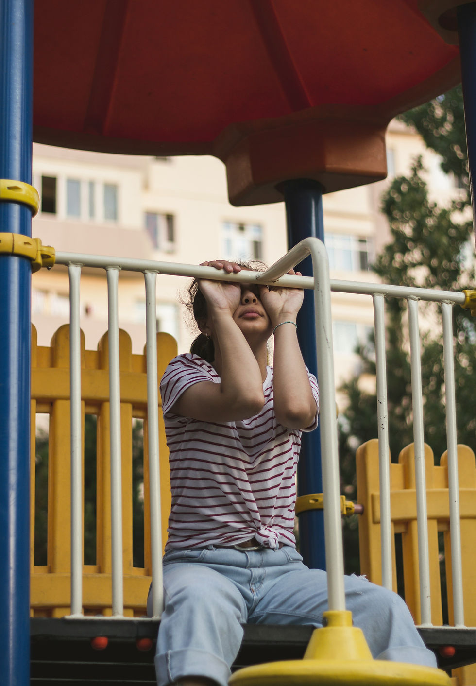 Adult person displaying childlike vulnerability, symbolizing how narcissistic abuse triggers regression, shared by narcissistic abuse recovery specialist Lynn Catalano.
