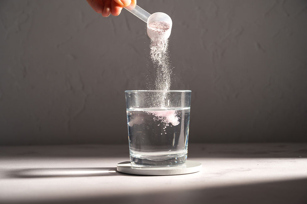 pouring creatine into a glass of water