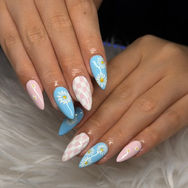 Baby blue almond shape Gel-X nail extensions with white cloud nail art design done at 312 Nails & Spa in River North, Chicago.
