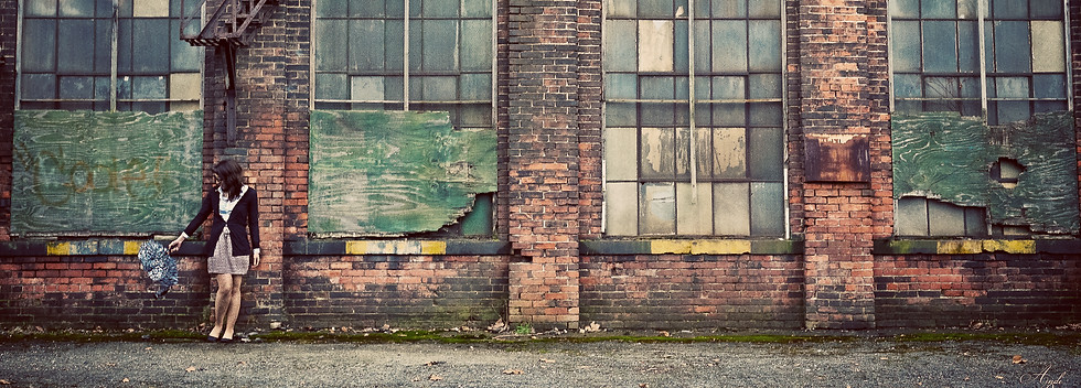 Girl standing outside of brick building