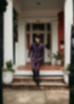 elopement groom walking down steps in front of a historic house in New Orleans