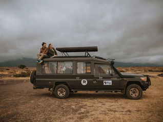 A wedding couple on a safari vehicle during their elopement in Tanzania