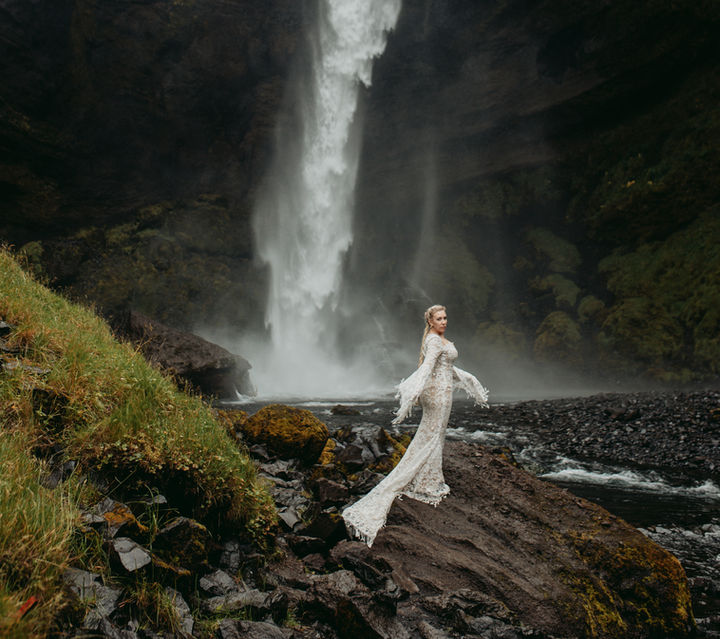 bride in front of a waterfall in the South of Iceland near Vik