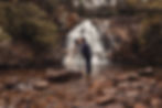 elopement couple kissing in front of a waterfall