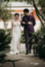 bride and groom walking through a tropical garden in New Orleans