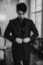 groom buttoning jacket