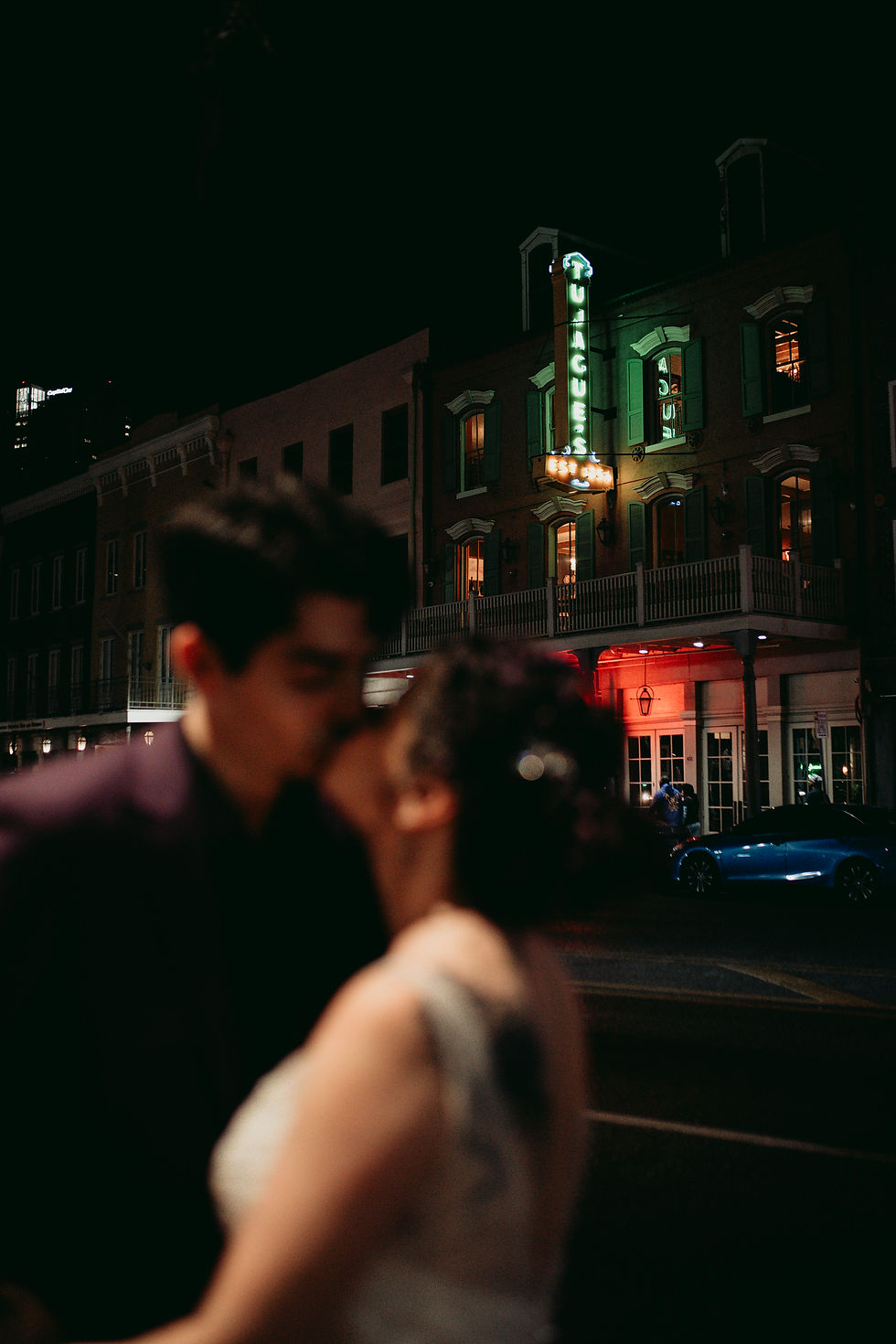 New Orleans wedding couple kissing by neon sign
