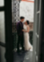 wedding couple on a balcony at the Rathbone Mansions