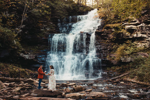 Wedding couple standing in front of Ganoga Falls in Rickett's Glen State Park in Pennsylvania near the Poconos