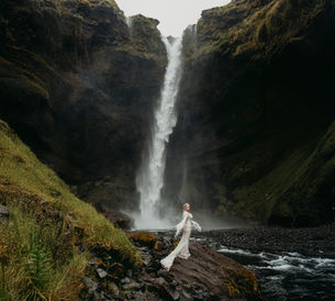 Bride in Iceland by a waterfall