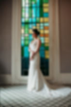bride in front of a stained glass window at the Rathbone Mansions in New Orleans