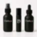 Three matte black Daeluge ritual vials: spray for lubricant, roller for anointing, and dropper for CBD massage oil.