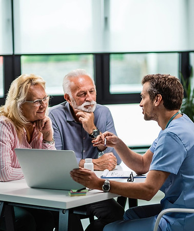 Healthcare professional consulting with an elderly couple