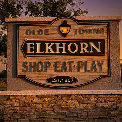 Olde Towne Elkhorn sign: Shop Eat Play Est. 1867