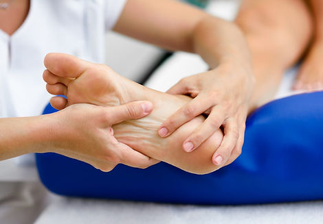 Physical therapist examining a patient's foot