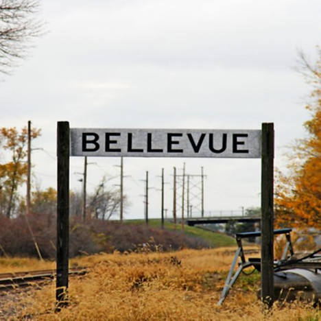 Bellevue sign by autumn railroad tracks in Nebraska.