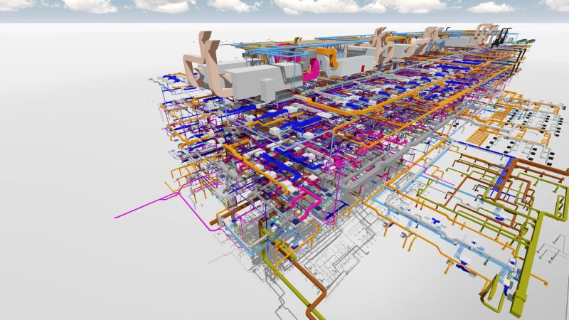 A complex 3D network of colorful pipes and ducts in a schematic design, viewed from above. The background shows a cloudy sky.