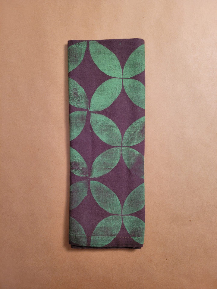 Green and brown bandana featuring overlapping botanical pattern, custom made with traditional block printing